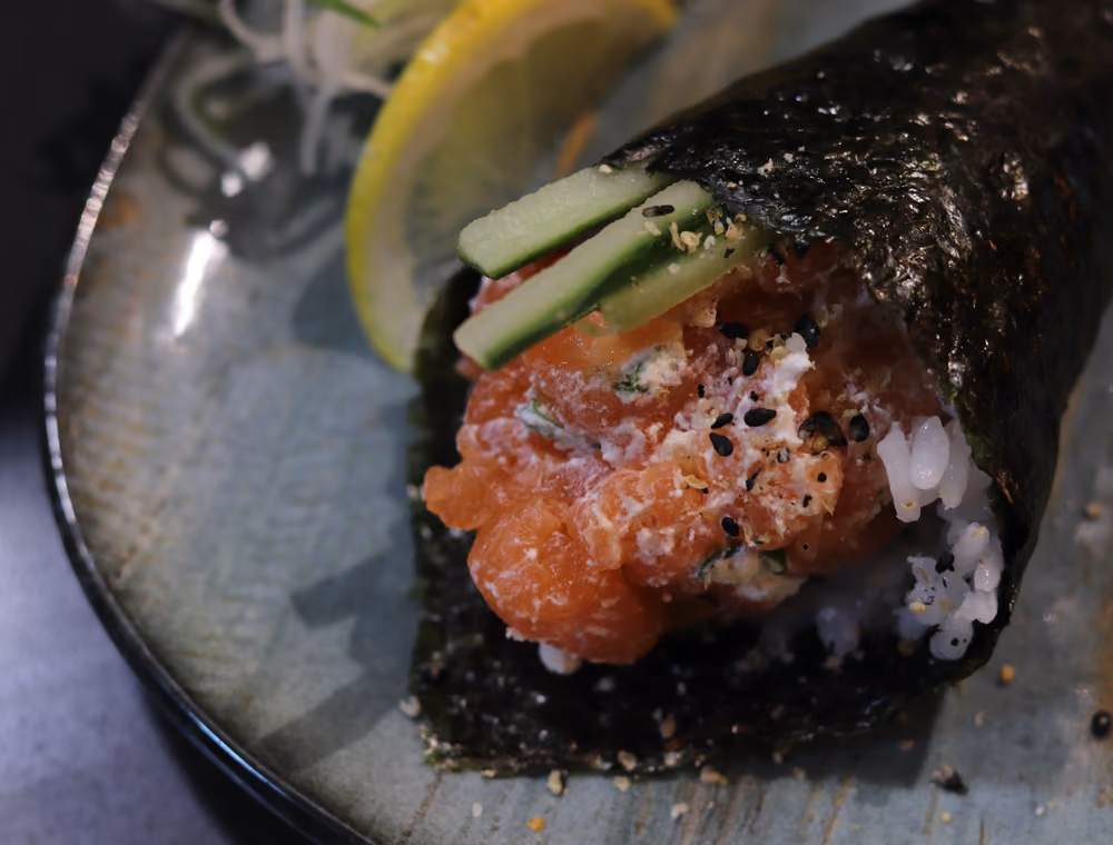A Sake Temaki hand roll of salmon, avocado and cream cheese at Hito