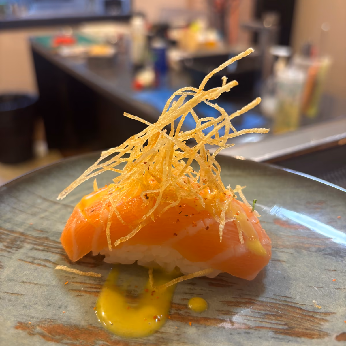 Nigiri Sake Especial - flamed salmon nigiri with a crisp topping - on a stoneware plate at Hito